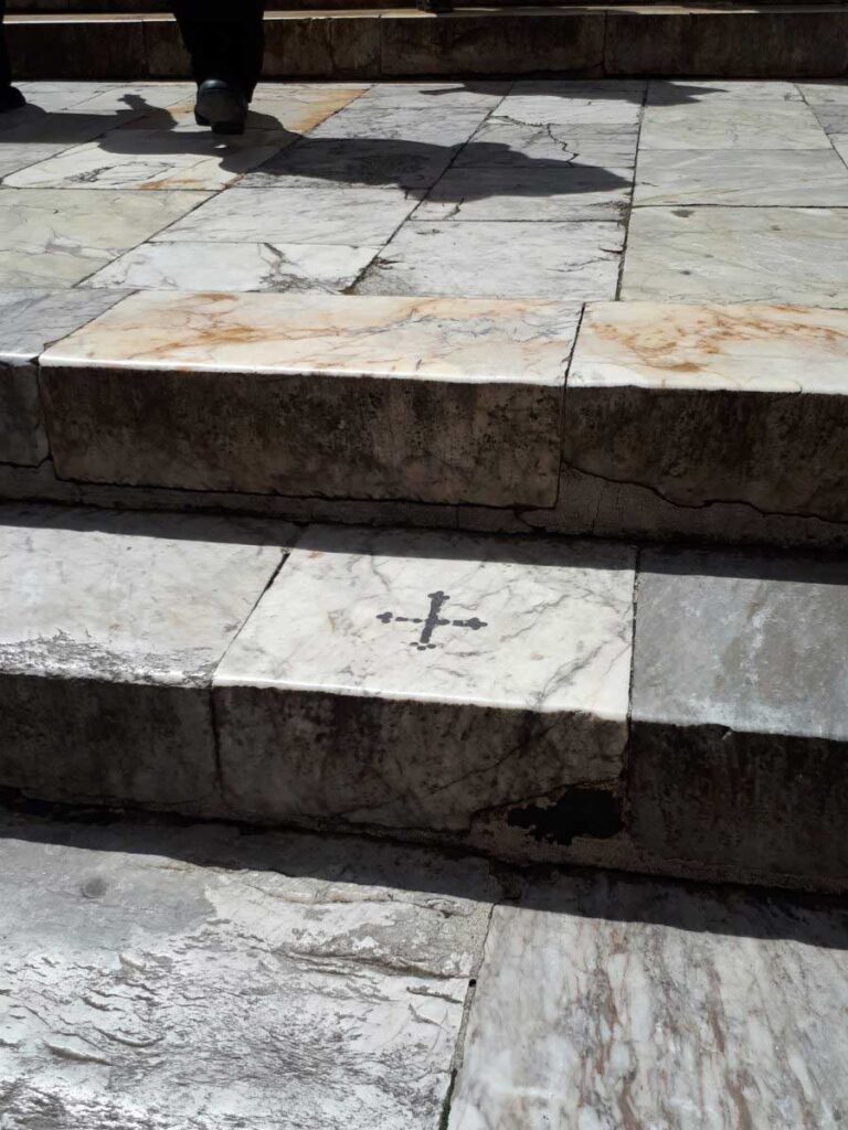 The cross on the staircase marks the point where Saint Catherine, according the tradition, fell pushed by the Devil.